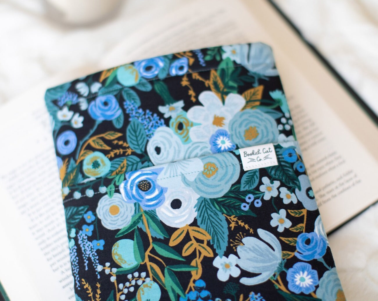 Large floral Garden Party blue toned book sleeve with black background